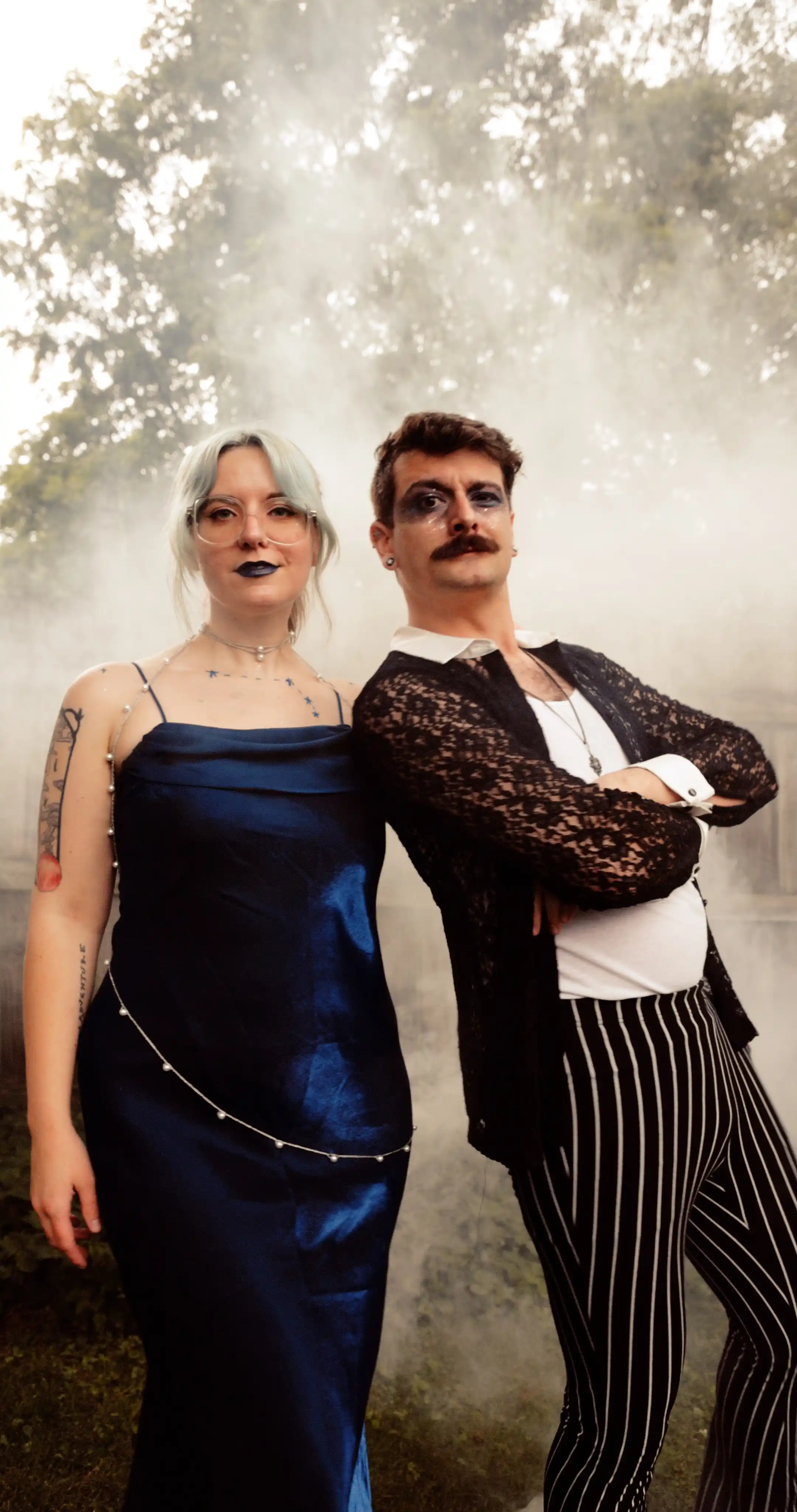 Bug on the left, dressed as the constellation Aries. Moss on the right dressed as a celestial gameshow host.