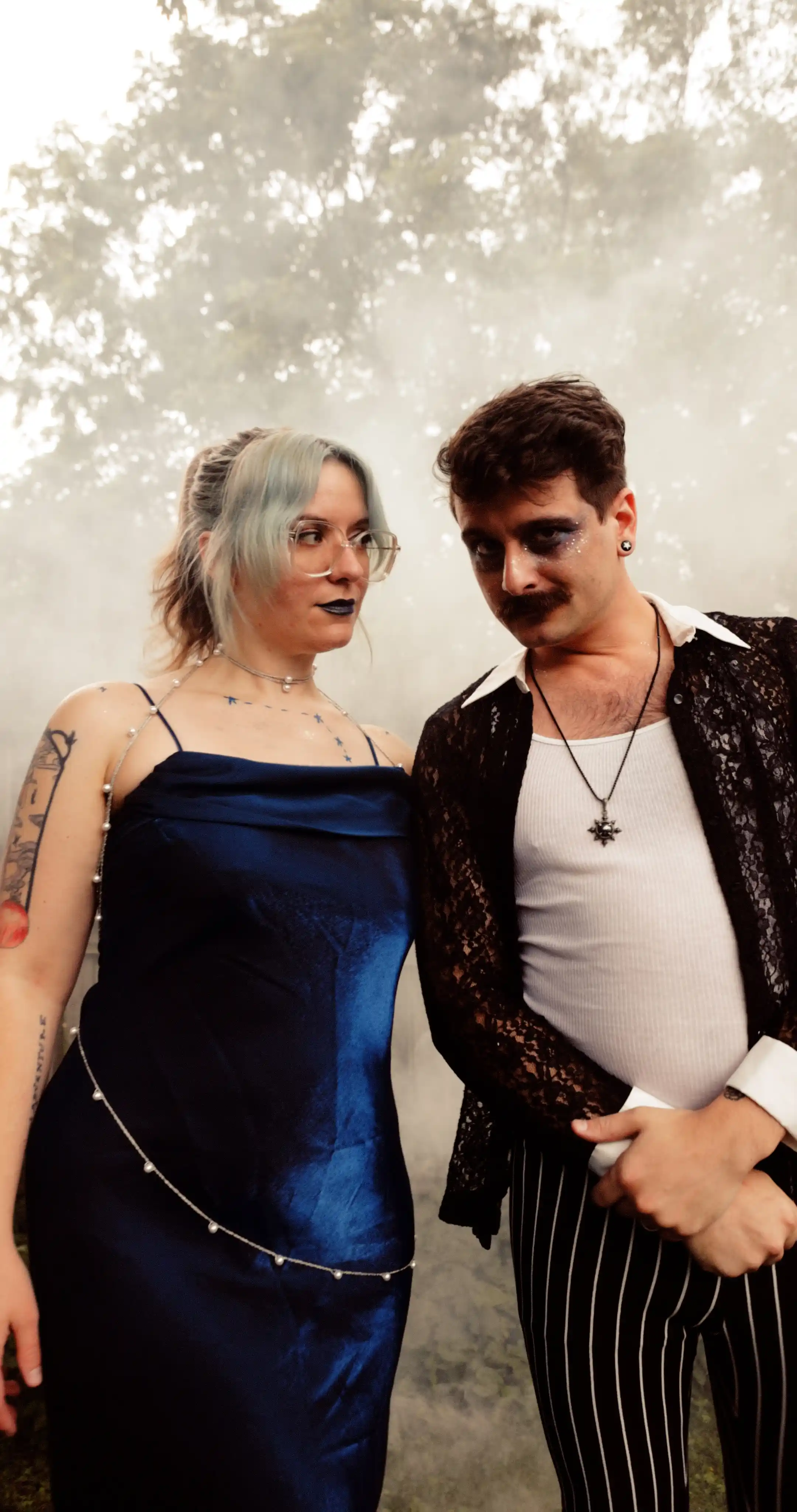 Bug on the left, dressed as the constellation Aries. Moss on the right dressed as a celestial gameshow host.