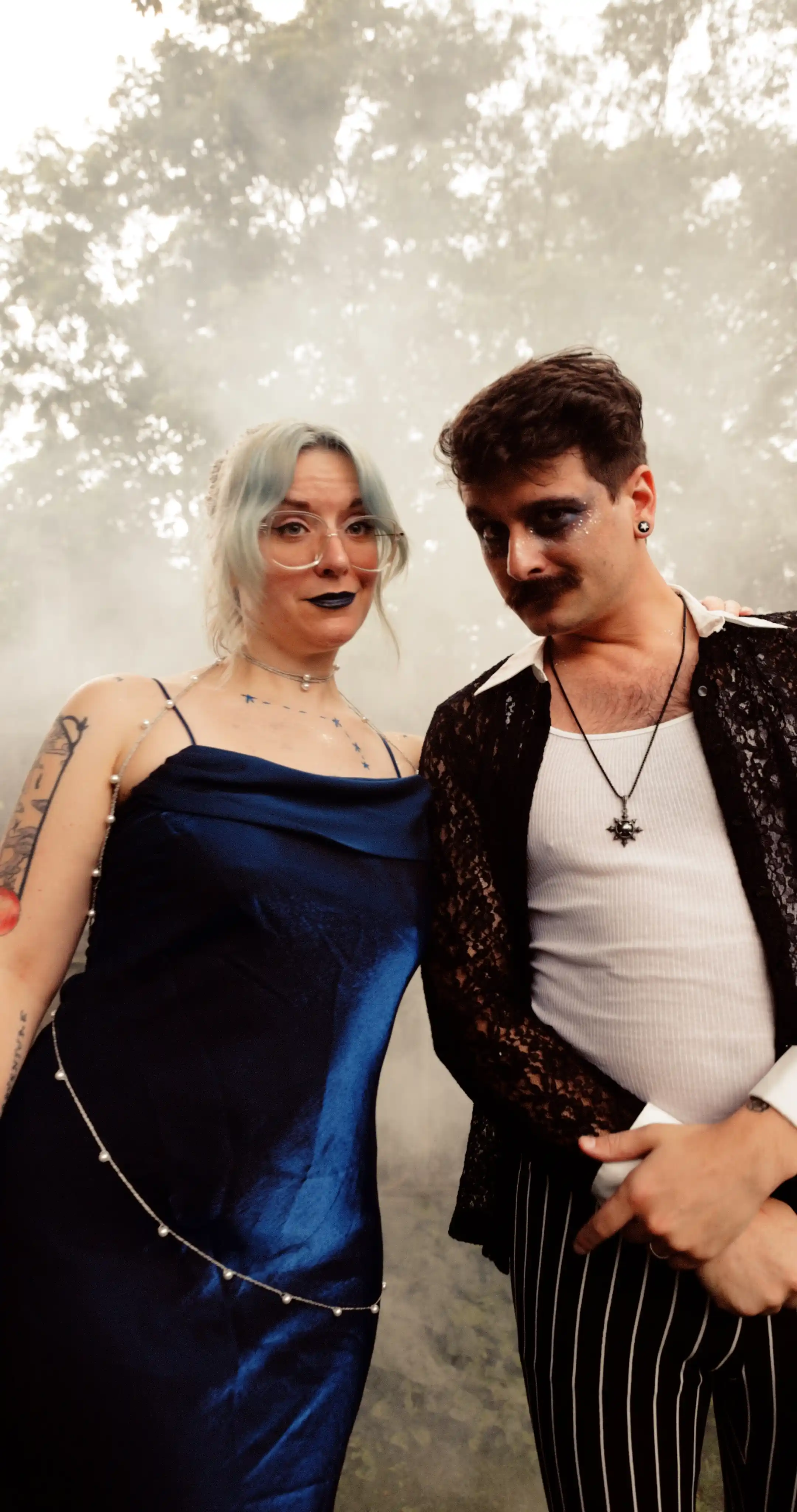 Bug on the left, dressed as the constellation Aries. Moss on the right dressed as a celestial gameshow host.