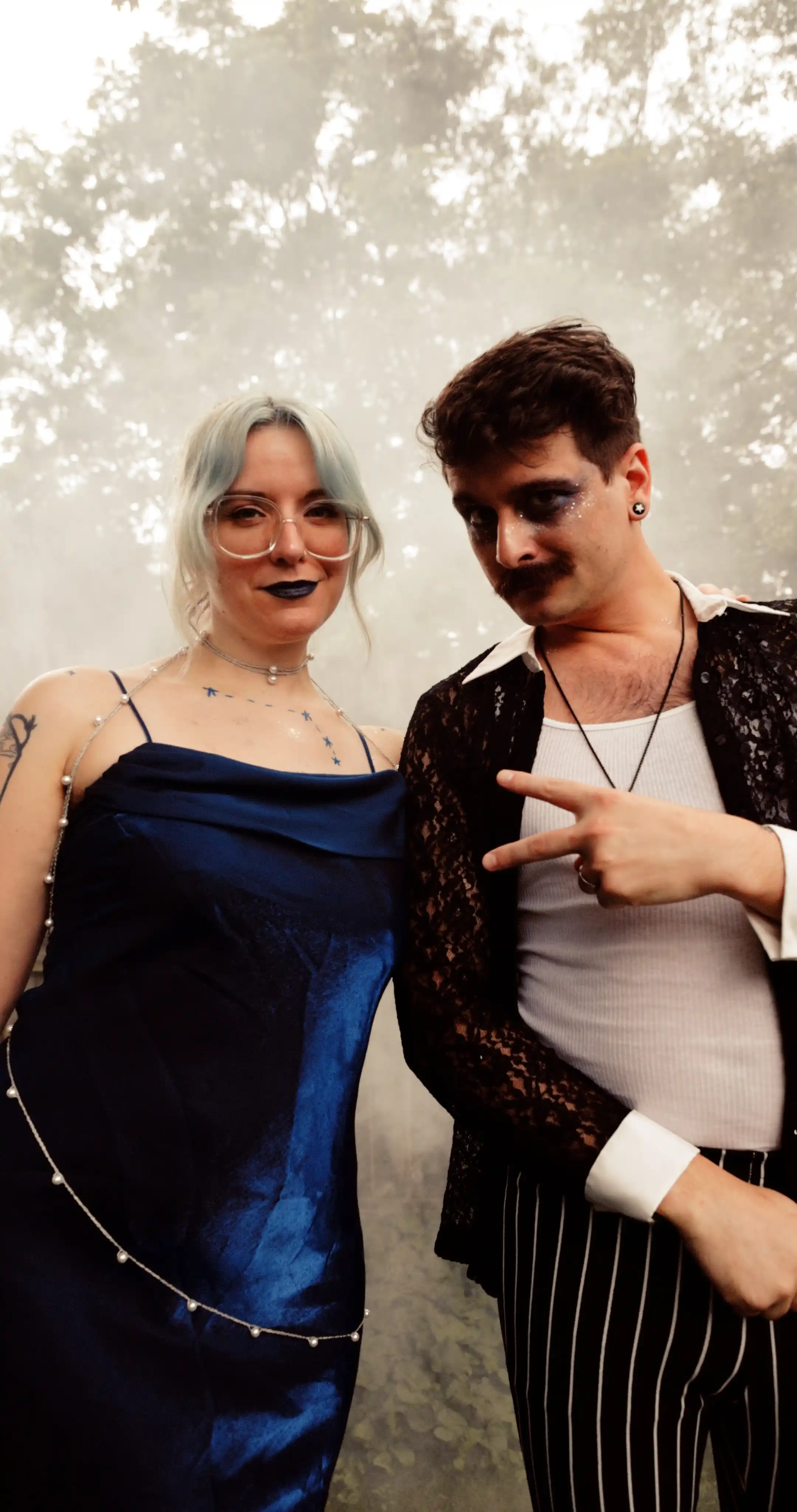 Bug on the left, dressed as the constellation Aries. Moss on the right dressed as a celestial gameshow host.