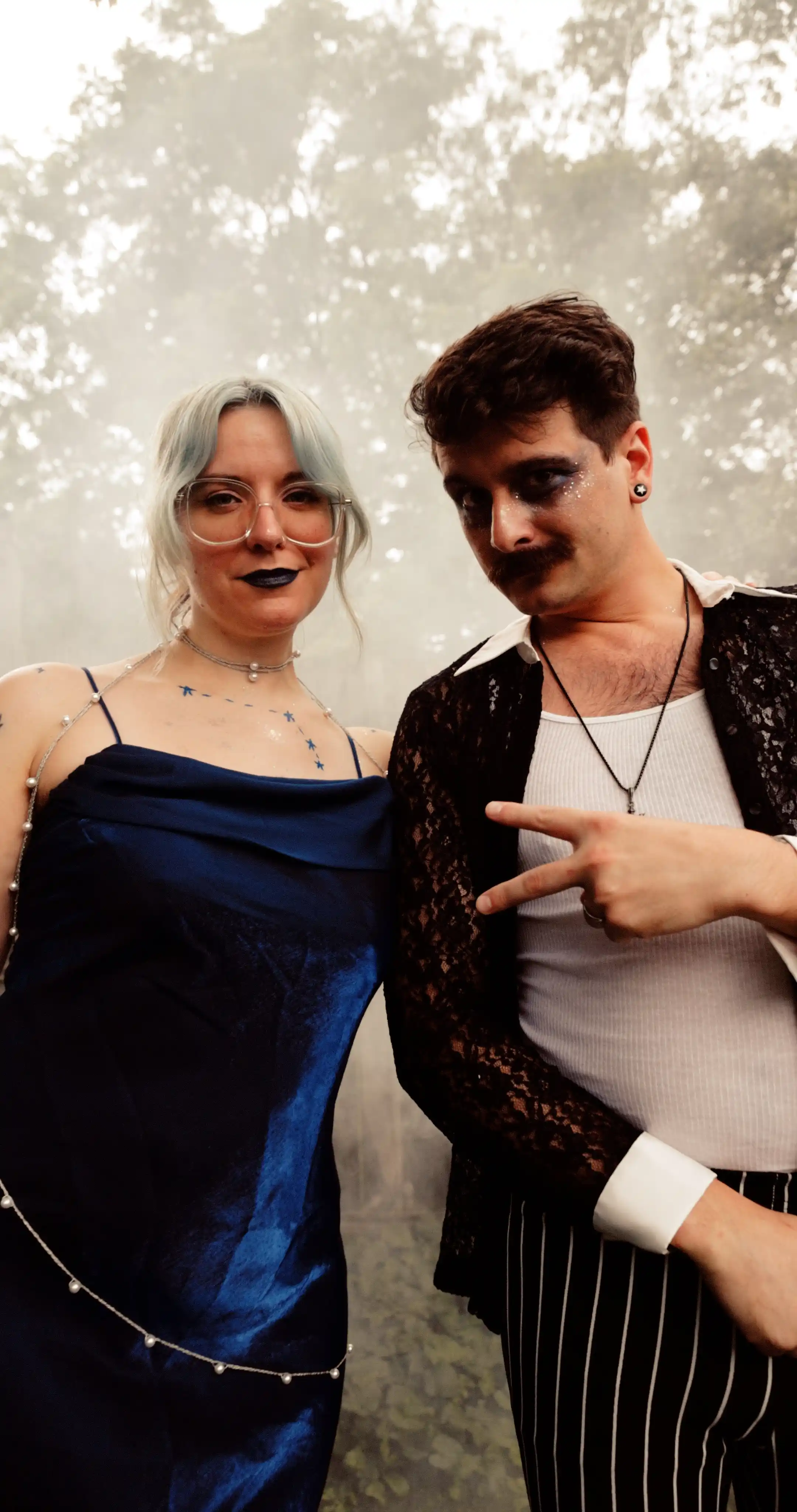 Bug on the left, dressed as the constellation Aries. Moss on the right dressed as a celestial gameshow host.