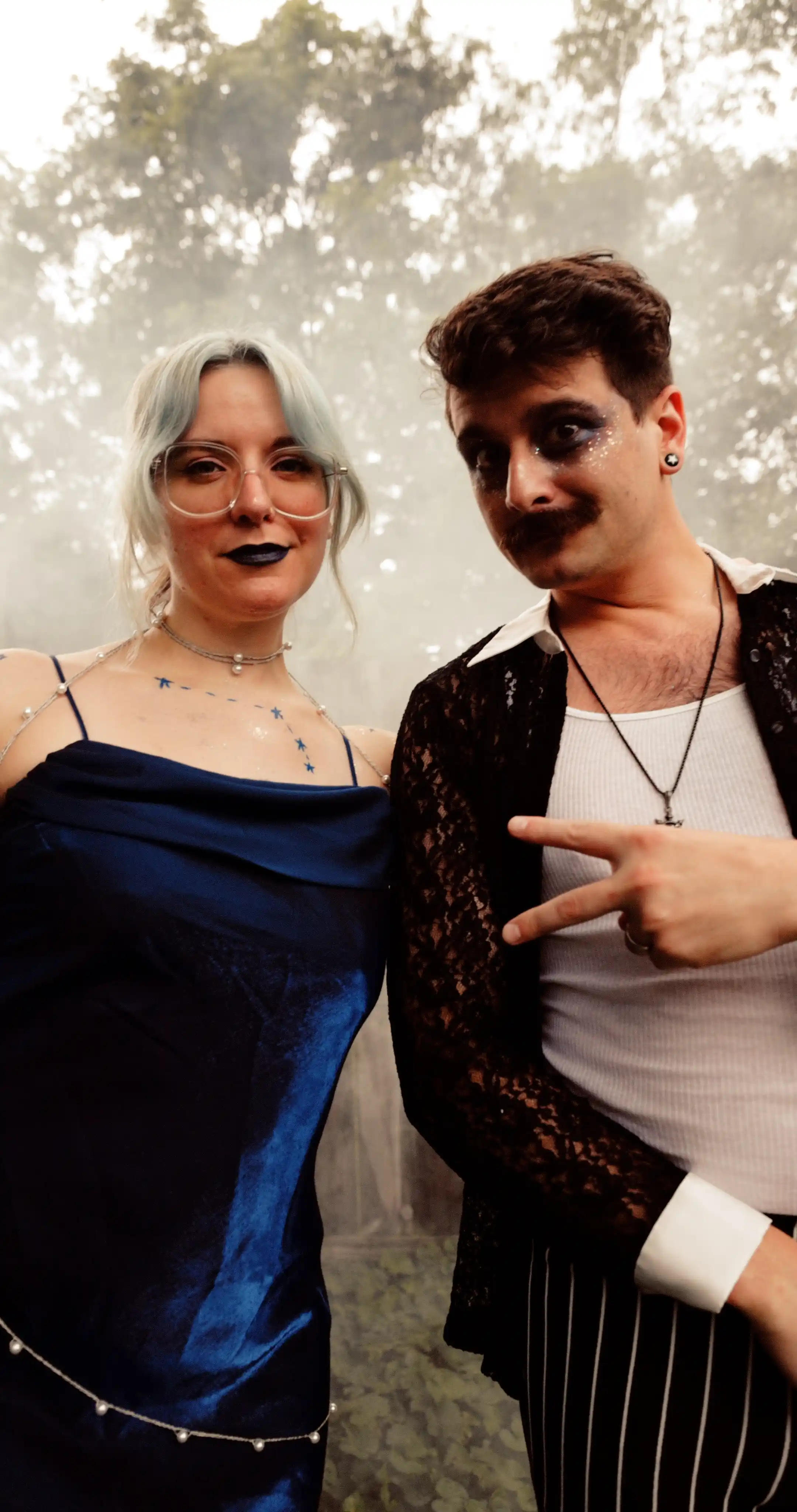 Bug on the left, dressed as the constellation Aries. Moss on the right dressed as a celestial gameshow host.